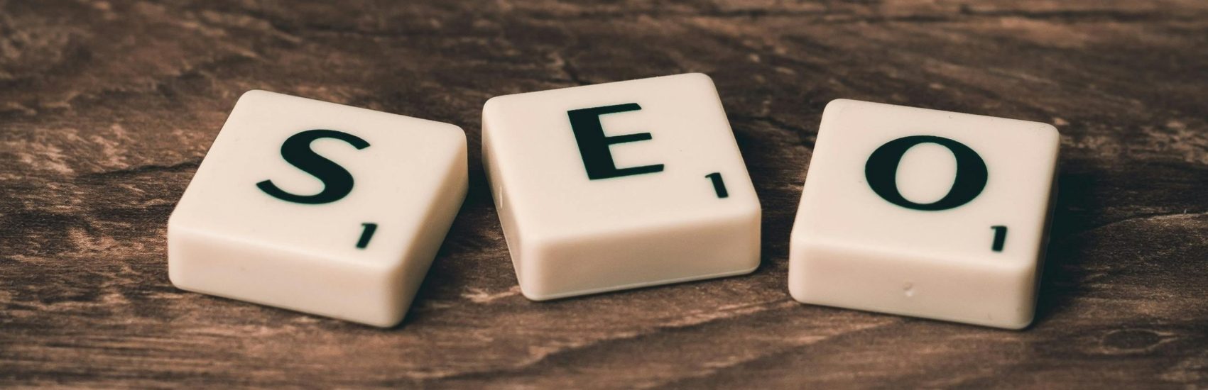 pexels-photo-270637-270637 Scrabble tiles spelling 'SEO' on a wooden surface. Ideal for digital marketing themes.
