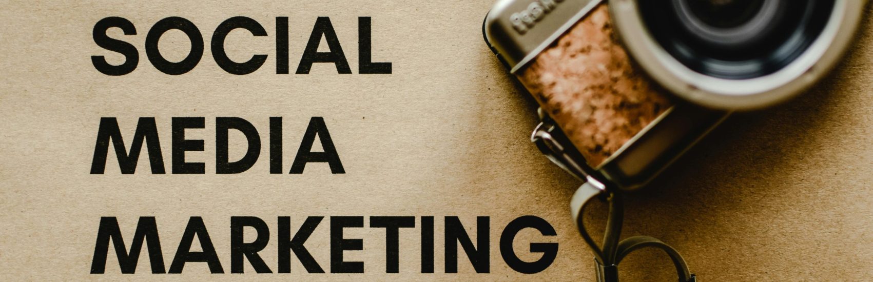 pexels-photo-6956301-6956301 A vintage camera on brown paper with 'SOCIAL MEDIA MARKETING' text, perfect for marketing visuals.